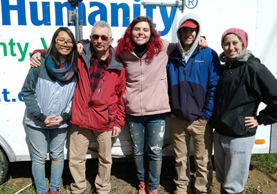 Photo of students and homeowner from a past Habitat trip|Photo of students and homeowner from a past Habitat trip