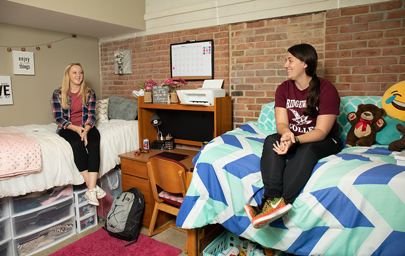 Two females inside dorm room