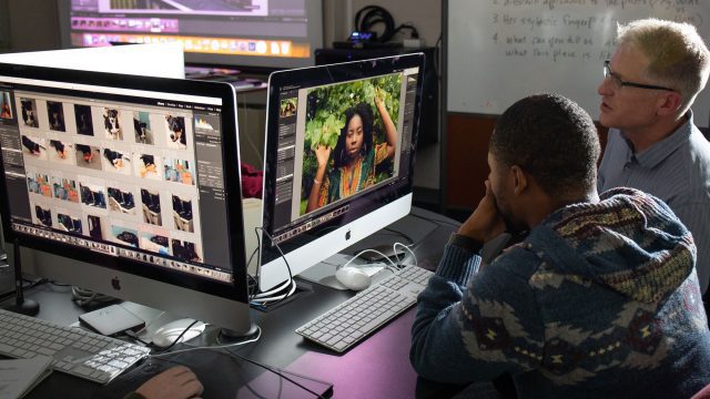 Student and professor study photograph on computer