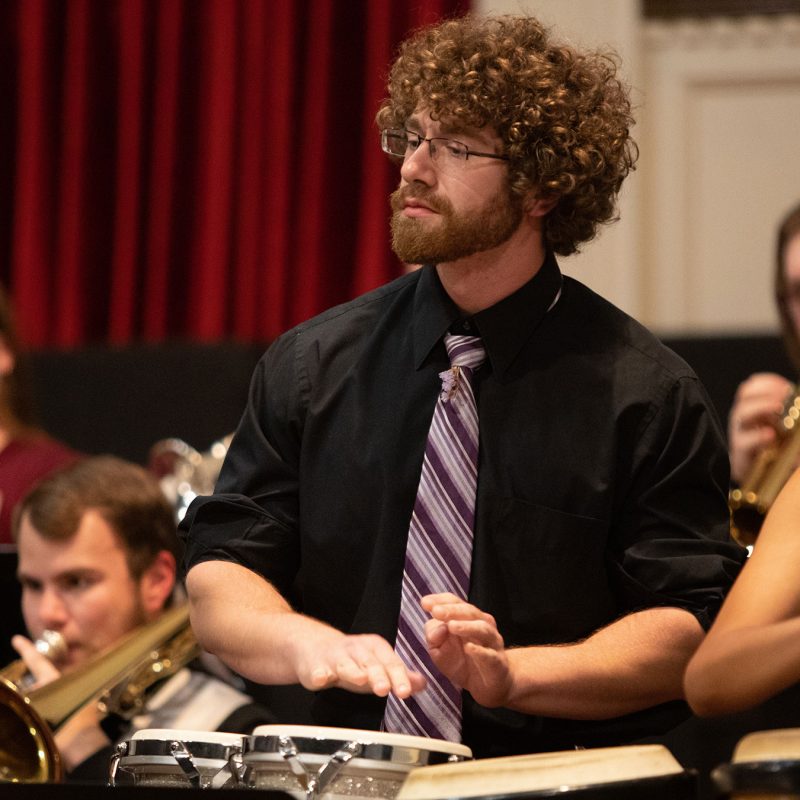 Male and female student playing bongos during a concert