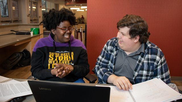 Male and female student studying inside KCC