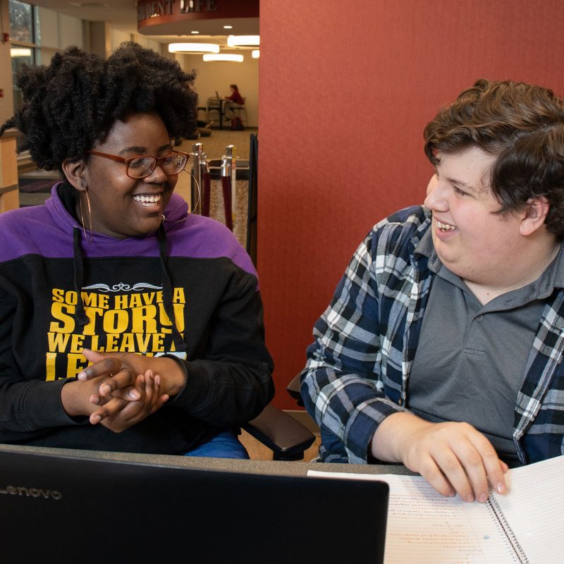 Male and female student studying inside KCC