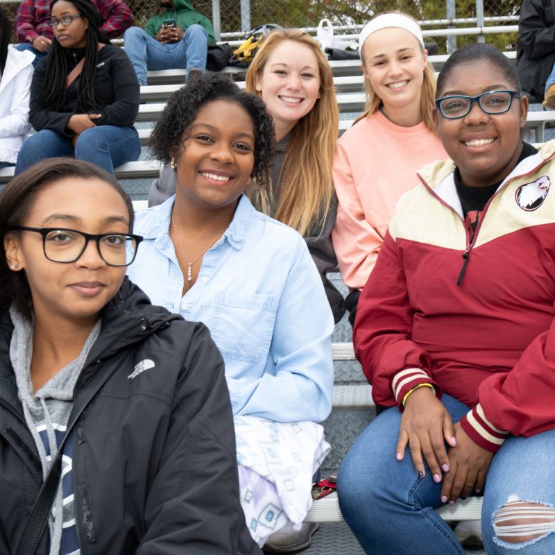 Five female students at a sporting event
