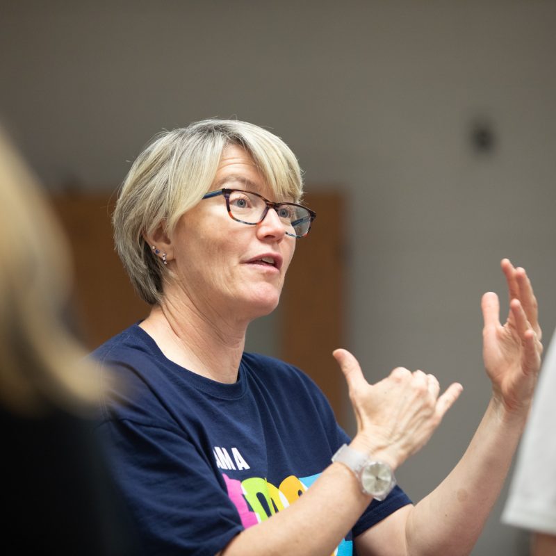 Female instructor speaks with students