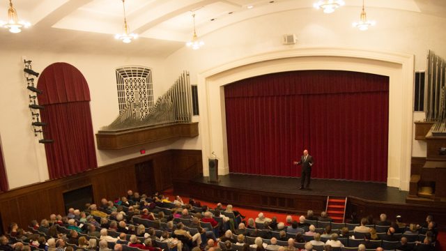 A speaker talks to a group in Cole Hall's auditorium