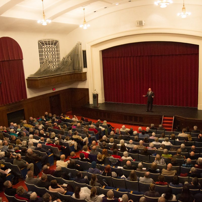 A speaker talks to a group in Cole Hall's auditorium