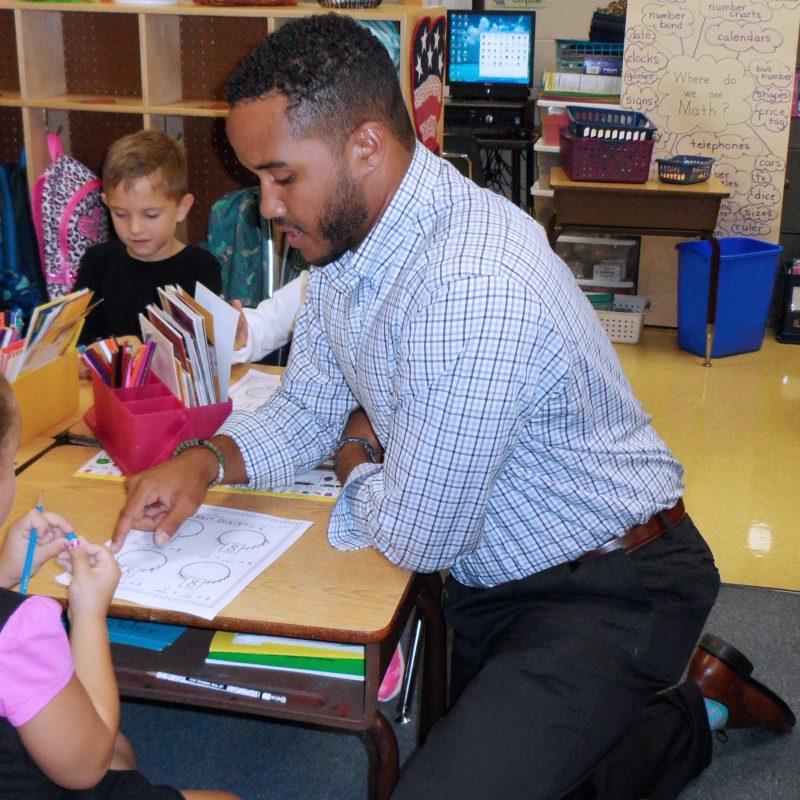 BC Students assists with elementary students.