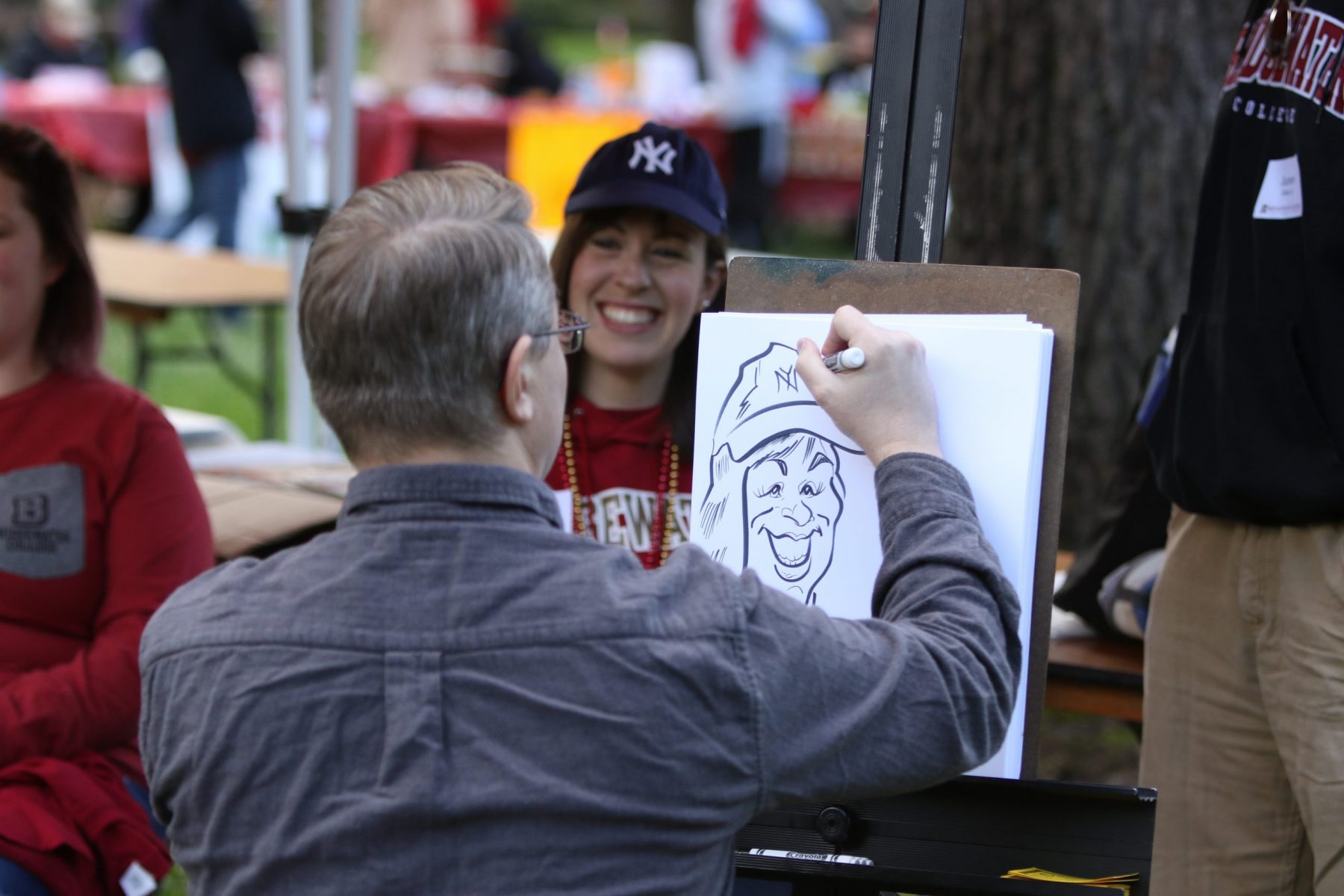 Man sitting down draws photo of woman sitting down