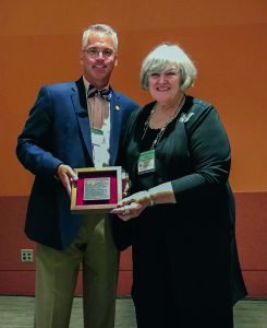 Man and woman hold plaque together