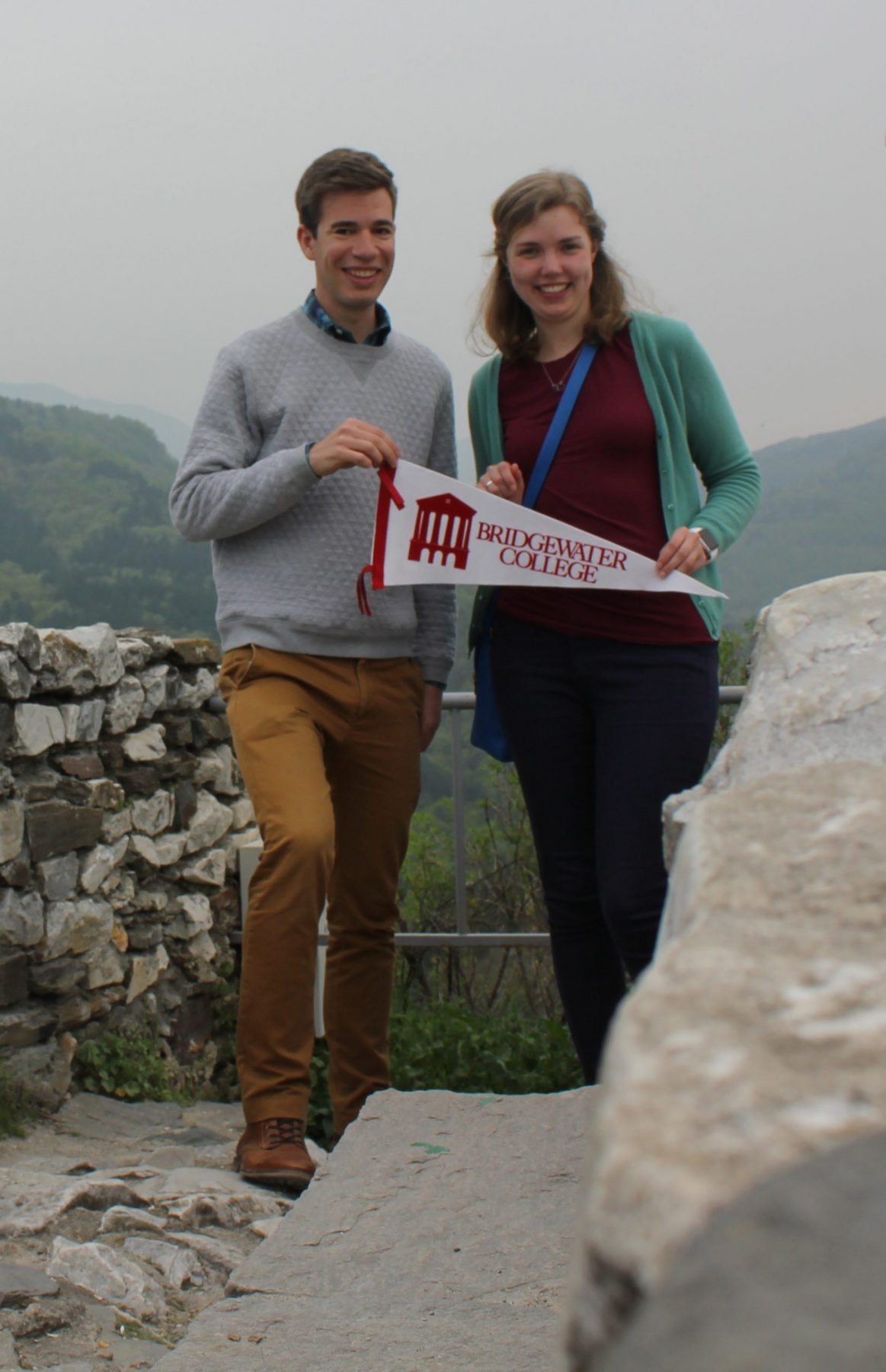 Man and woman hold a pennant that says Bridgewater College