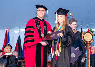 President and student on stage