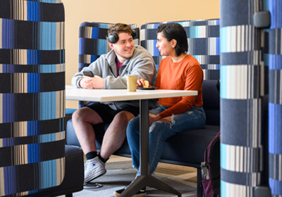 Two people sitting in a booth