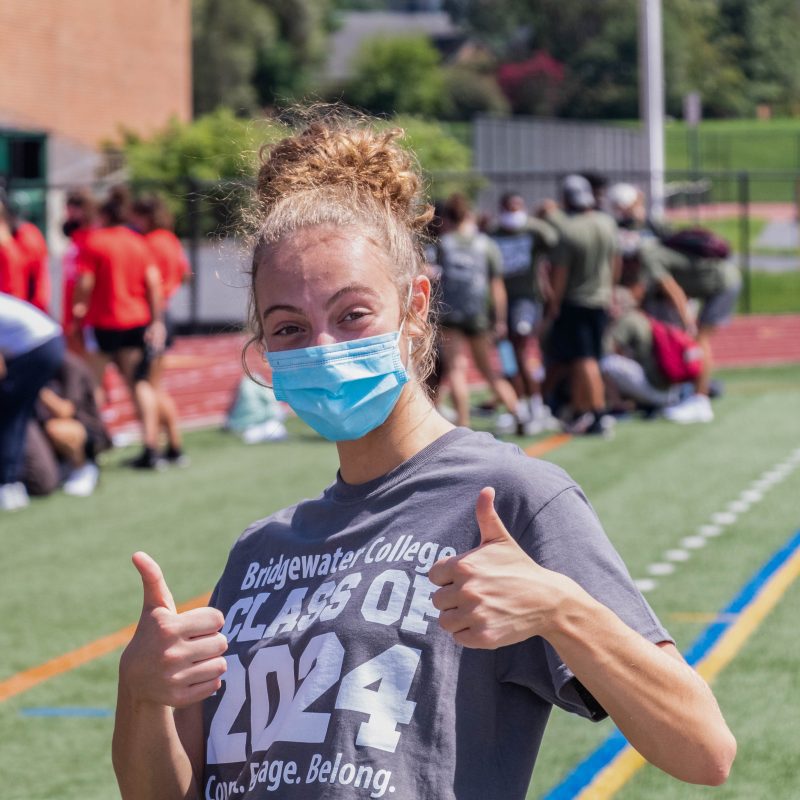 Woman with class of 2024 t-shirt on giving a double thumbs up