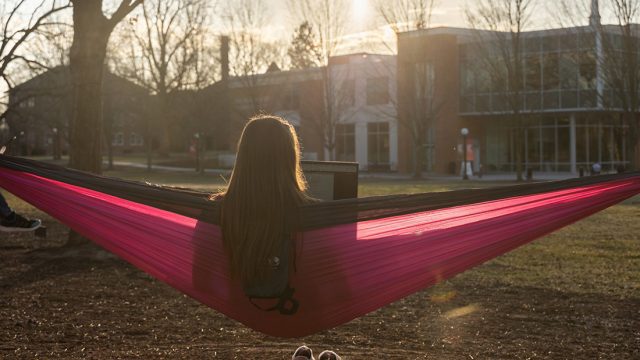 Student in Hammock on campus