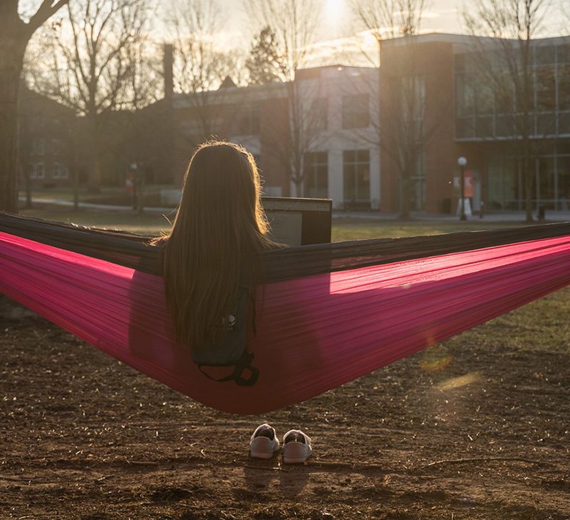 Student in Hammock on campus