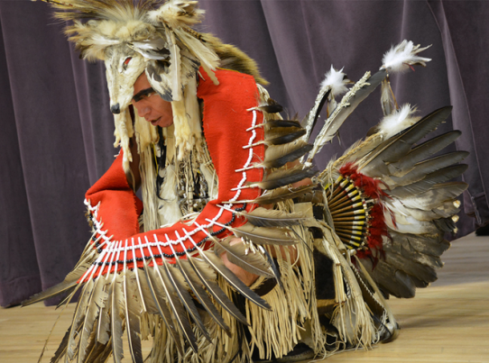 Native dancer covered in feathers