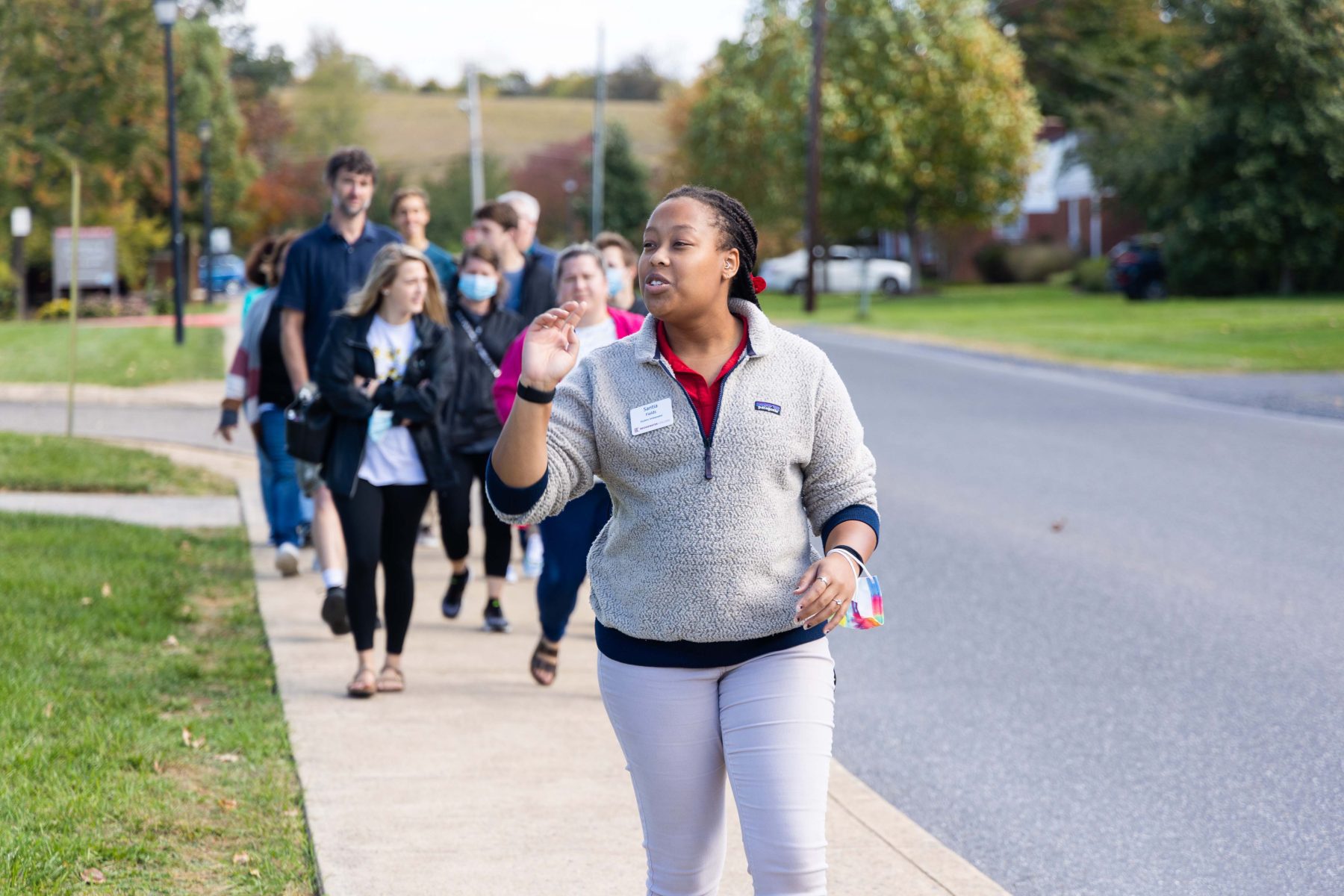 Student tour guide leading a group around campus