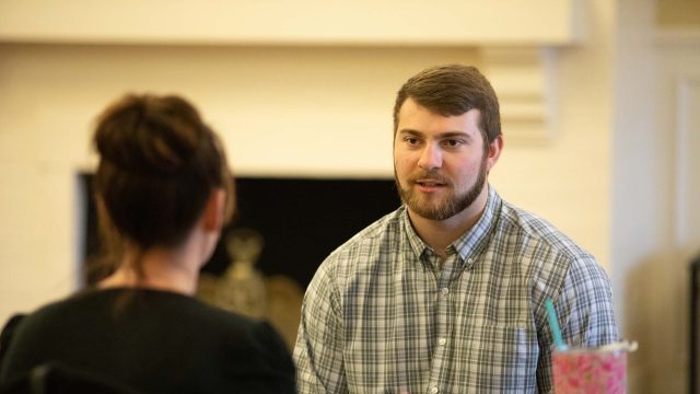 Man speaking to women during mock interview