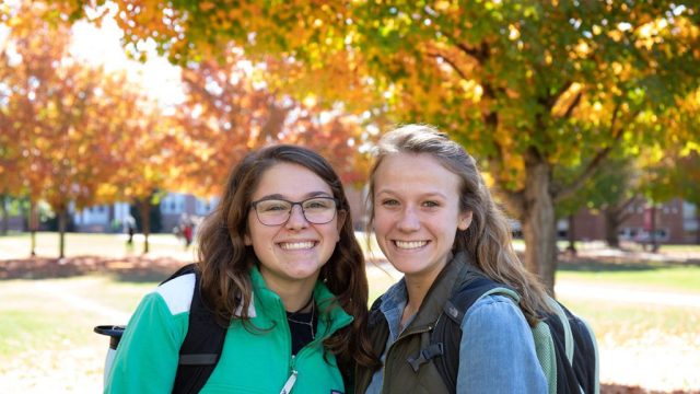 Two students standing next to each other and smiling during admitted students day