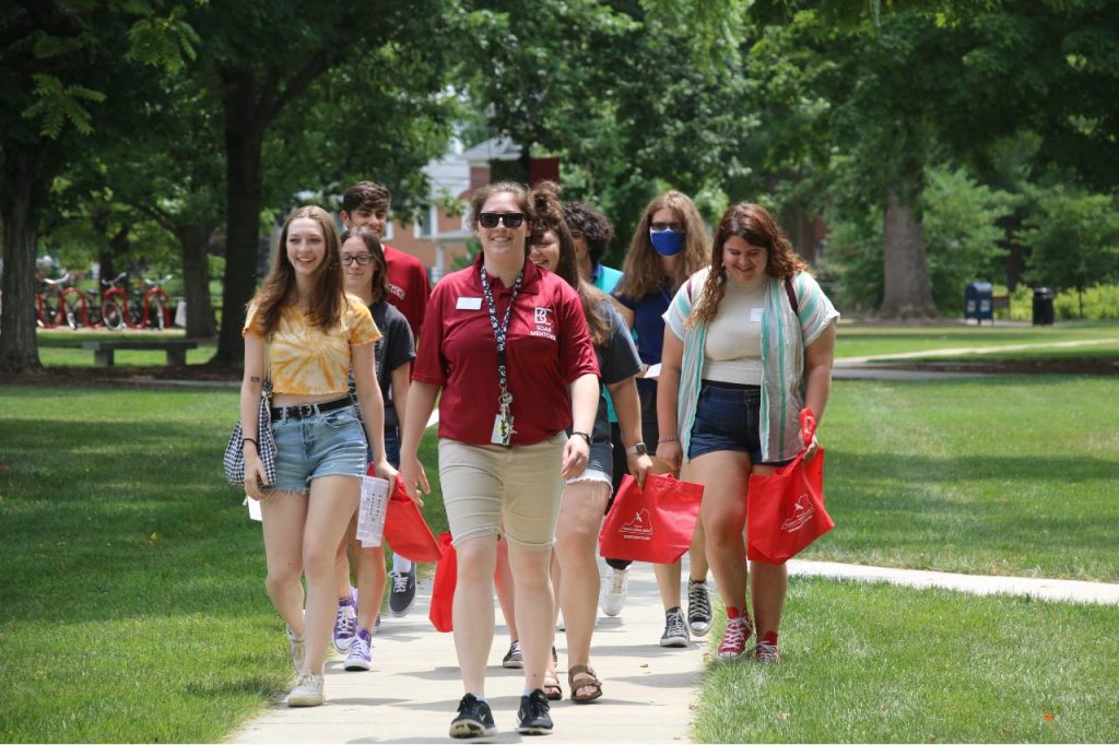 Soar mentor leading a group of students on a tour of campus