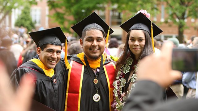 Three Bridgewater graduates posing for a photo together