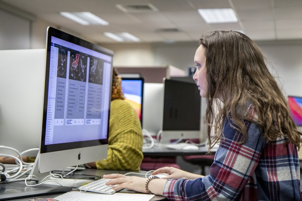 Female student working on Mac desktop