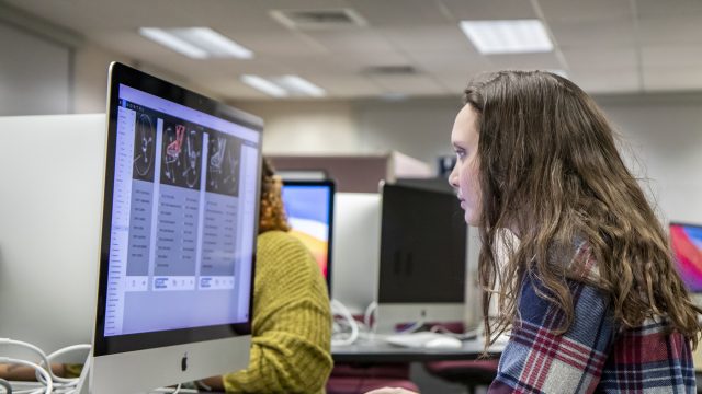 Female student working on Mac desktop