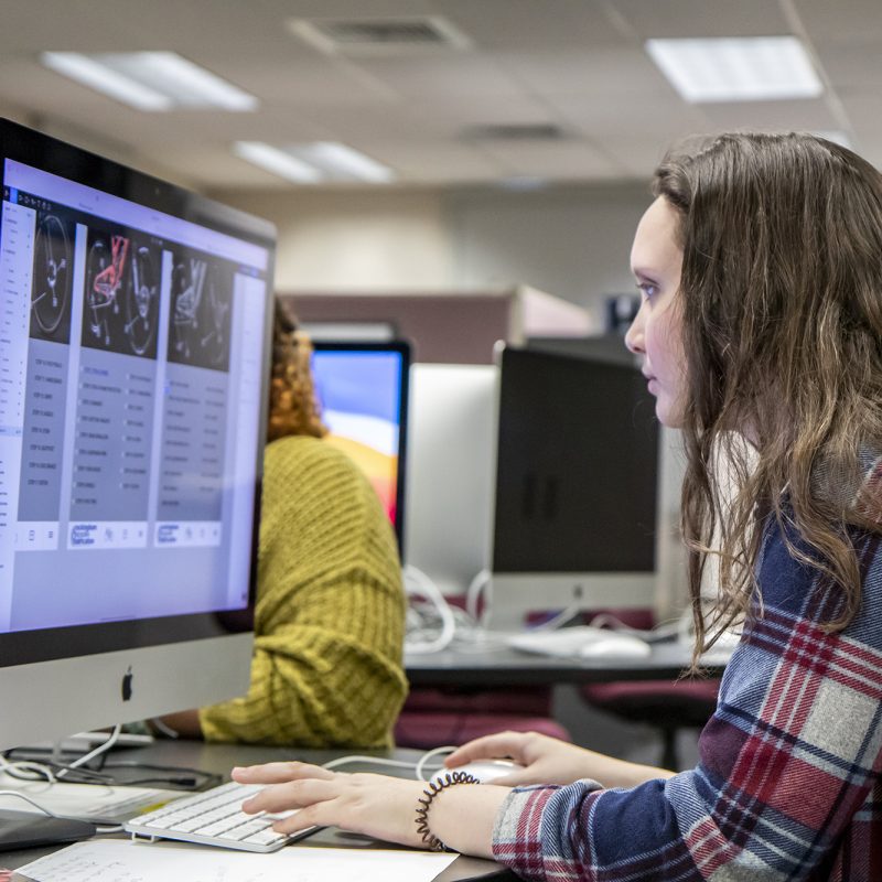 Female student working on Mac desktop