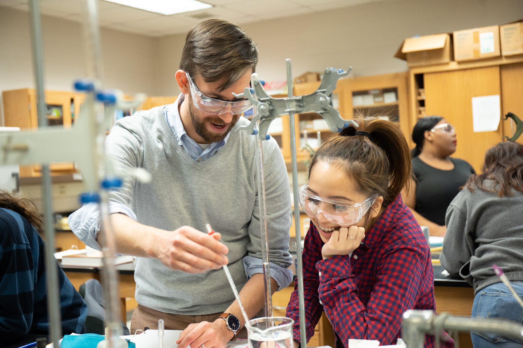 Professor helping student in chemistry