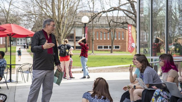 Professor teaching a class outside the F-L-C