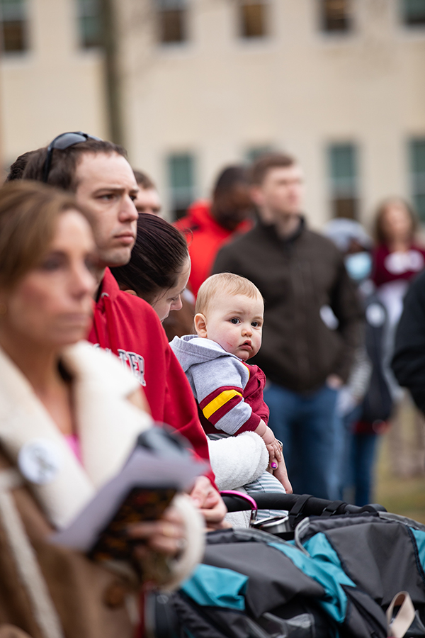 A mother holds her baby at remembrance event