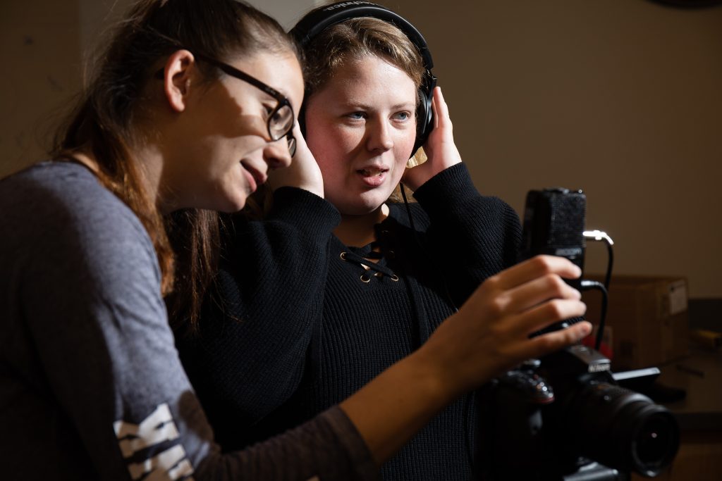 2 people working with audio recorder