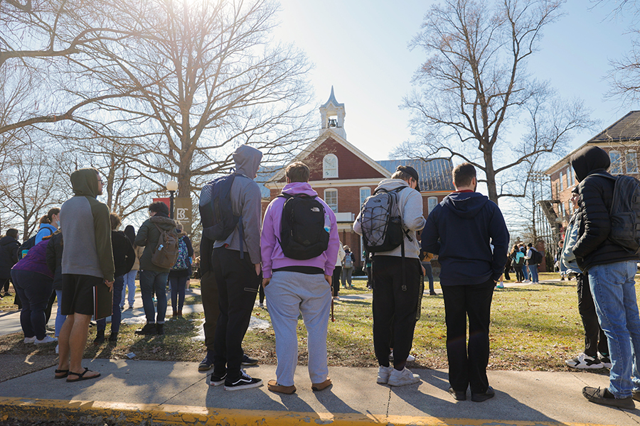Students gather around the Memorial Hall bell