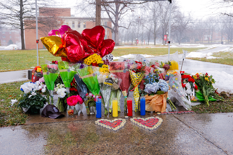 Flowers, candles and balloons at the Flory Hall memorial site