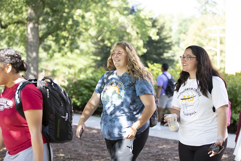 Two female students walk side by side outside on Bridgewater College's campus for the first day of classes for the 2022-2023 academic year.
