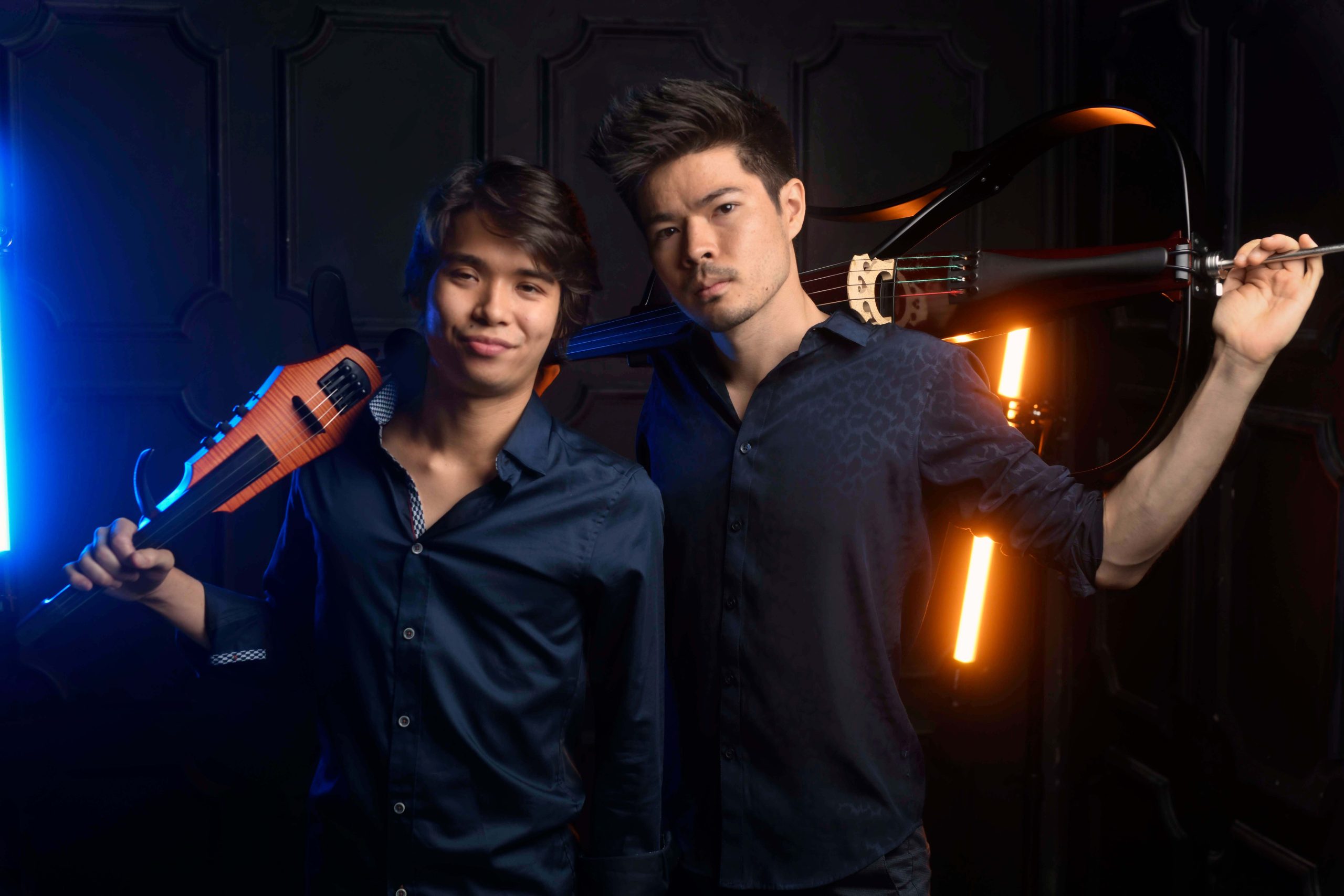 Two members who make up the band ARKAI pose with their string instruments