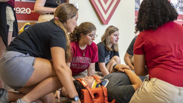 Athletic training students learning to use spine board