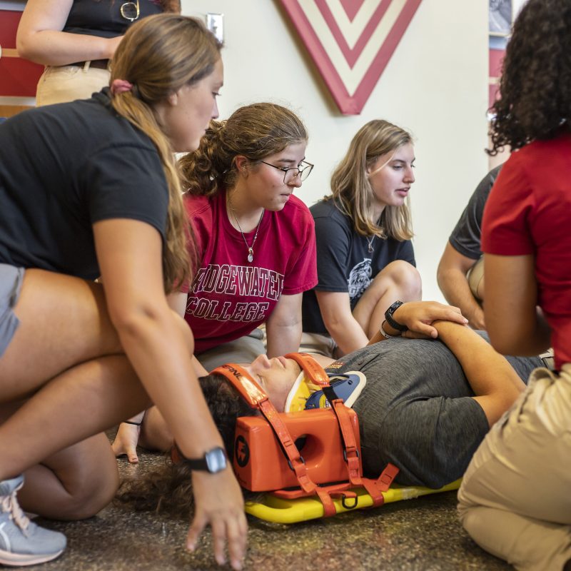 Athletic training students learning to use spine board