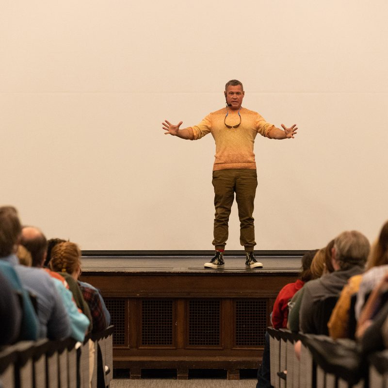 Jeff Corwin on stage with outstretched arms