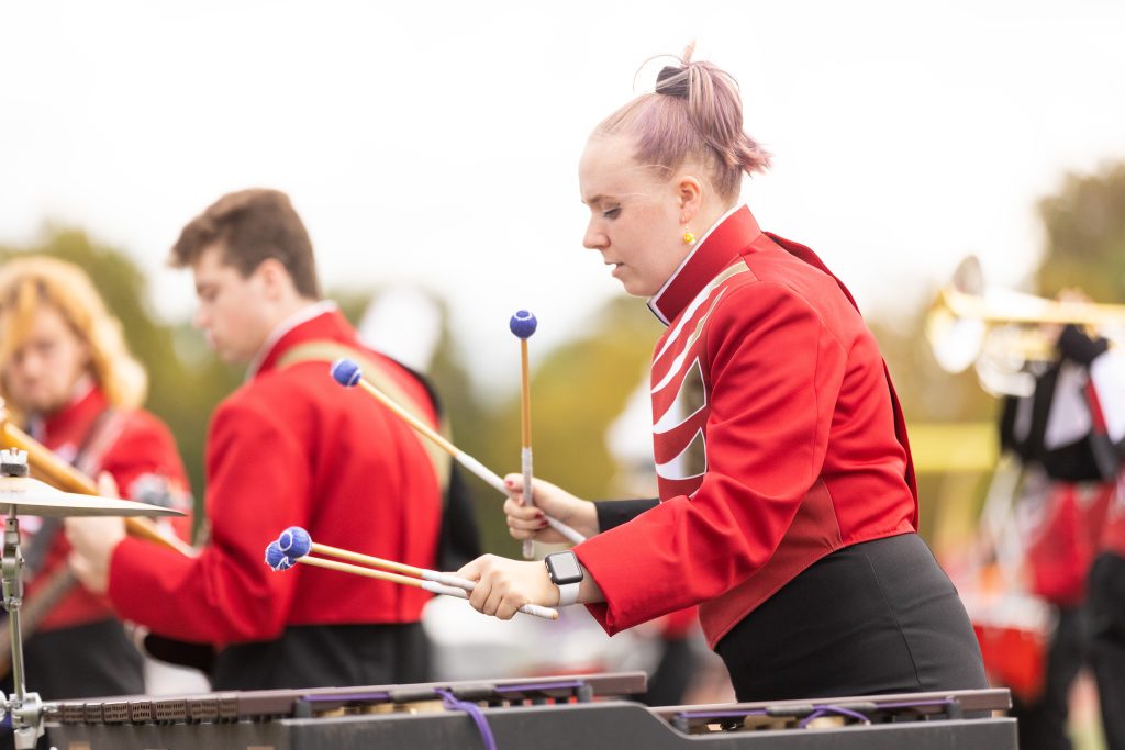 Female playing percussion instrument in the marching band