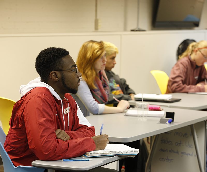 Students sitting in classroom taking notes