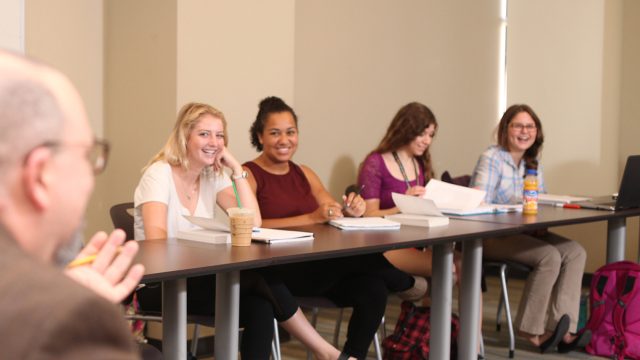 Students sitting in classroom smiling