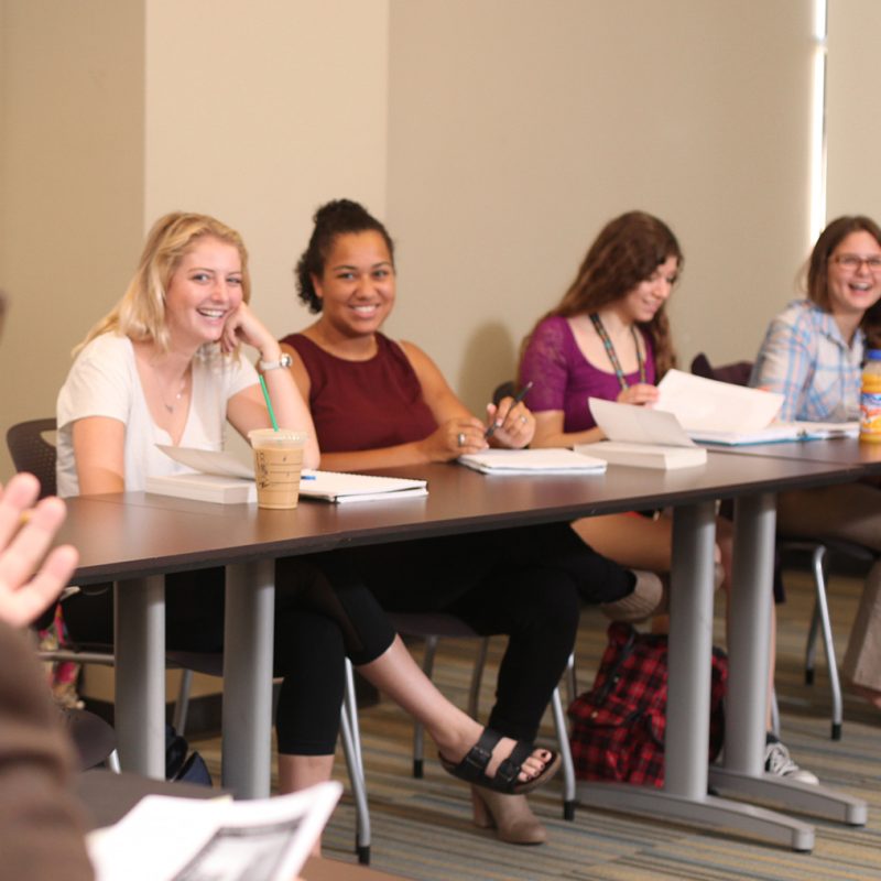 Students sitting in classroom smiling