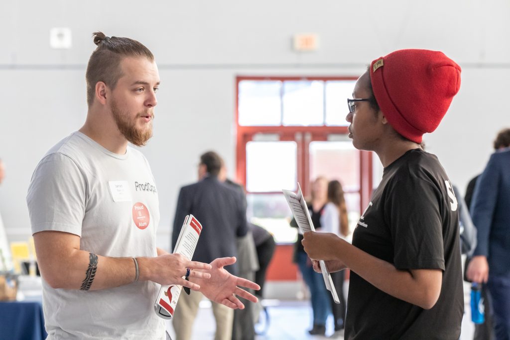 Employer speaking with student  at career exploration day