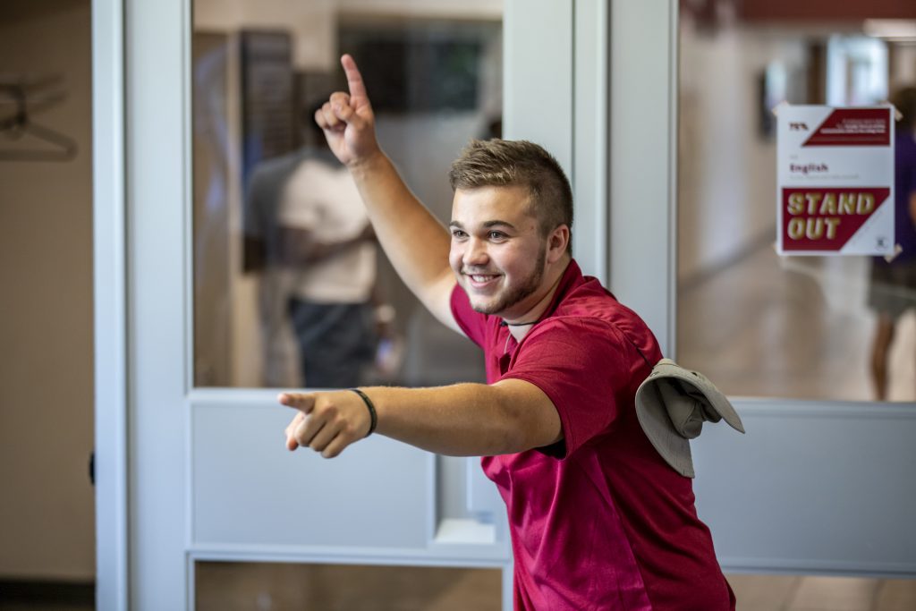 Student ambassador smiling and pointing