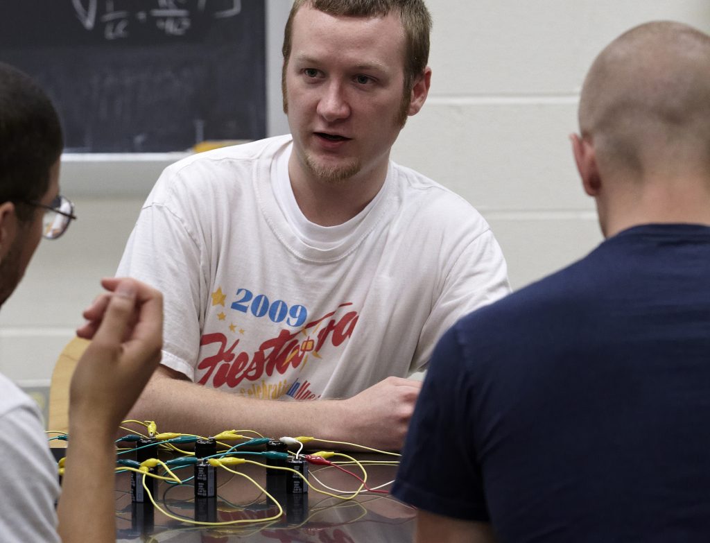 Student sitting at table during physics lab