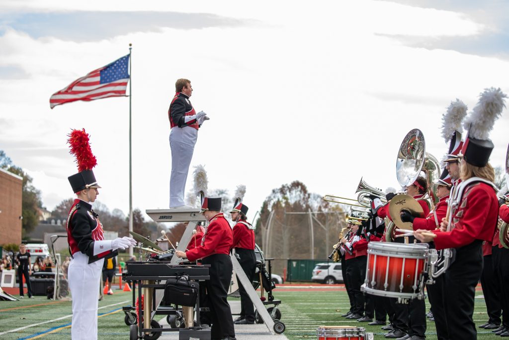 Members of Bridgewater College's Screamin' Eagles Marching Band performing on the football field during halftime