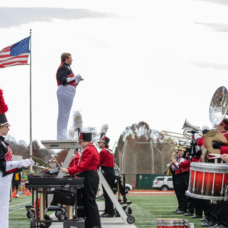 Members of Bridgewater College's Screamin' Eagles Marching Band performing on the football field during halftime