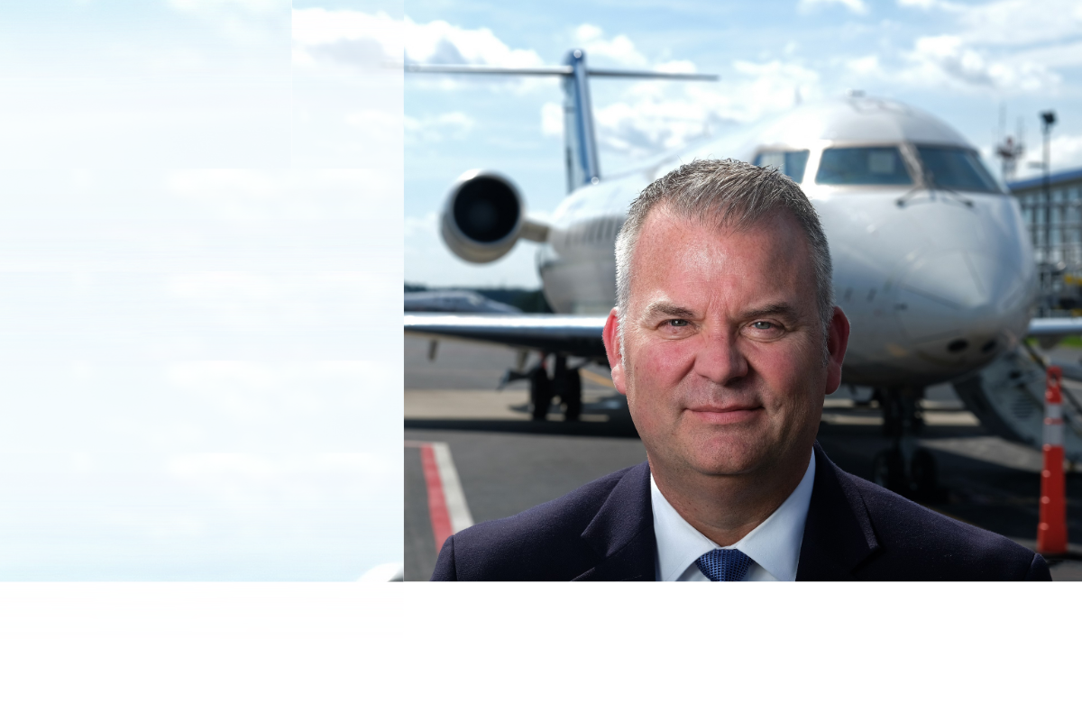 Greg Campbell standing in front of an airplane.