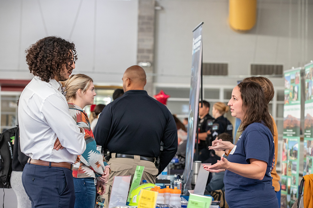 Student talking to employer at career exploration day